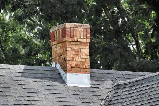 Two-tone brick chimney with fresh flashing